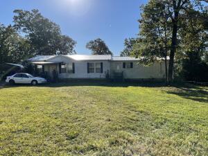 This 59 acres includes a doublewide mobile home with 3 bedrooms and 2 baths, a 30x60 shop with living quarters and a workshop close to Bull Shoals Lake. With a little work you will have a view of the lake. Lots of possibilities with this property.