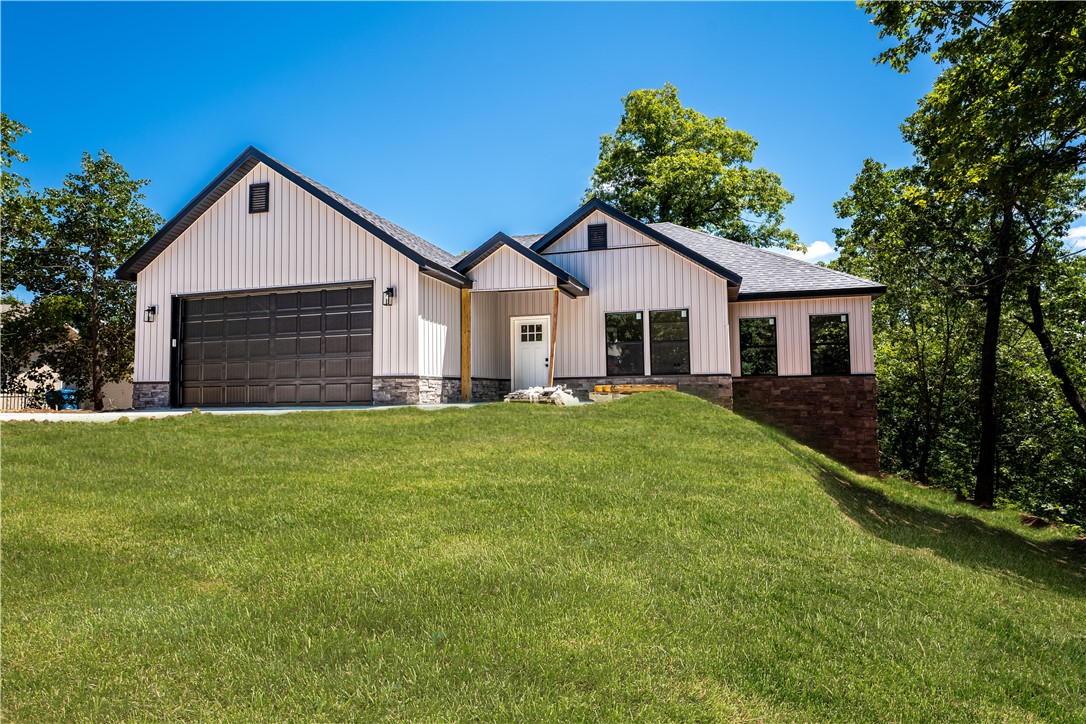Welcome home to this gorgeous new construction home on a mostly FLAT 0.46 acre lot on fantastic cul-de-sac with several other new homes. Close to Tunnel Vision bike trail, Highlands Golf, and Loch Lomond/Lake Pointe. Private beautiful back yard setting with large covered deck for entertaining and enjoying the beautifully wooded views and plenty of flat yard for pets, fire pit and more. 4 bed/office, 2 bath with many custom touches including thick granite counters throughout, shiplap walls, floor to ceiling stone floating gas fireplace, beautiful LVP in main areas. Open kitchen, dining and great room to host large gatherings! Large Owners retreat with ensuite including elegant tile shower, soaker tub and giant dual closets designed to pamper the owner! Unexpectedly large laundry/mud room and pantry to provide ample storage and functionality! Great front patio with lots of shade and privacy to enjoy NWA outdoors! All set in Bella Vista - golf, tennis, lakes, trails, parks, exercise facilities and more!