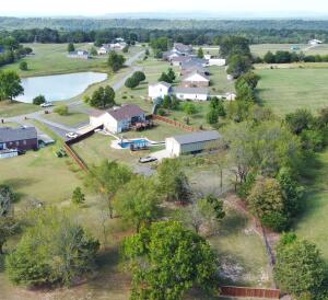 This beautifully updated home has it all, including an assumable 3% interest rate for qualifying buyers! All sitting on 1.80 acres in a prime area you will find this 3 bedroom 2.5 bath home has all your needs met. Off the front porch you have a view of the stocked community pond. Out back there is a large deck for gatherings, grilling, a hot tub, a lap pool which also has a slide and diving board. The 30 by 60 ft shop has ample storage for all your hobbies, tools and toys. 900 sq ft of the shop is heated and cooled with its own laundry room, on demand hot water tank, and plumbed for a bathroom. You will also find a cedar privacy fence, storm shelter, and a whole house generator. Inside this lovely home you will find granite/quartz countertops, stainless steel appliances & walk-ināāāāāāāāāāāāāāāāāāāāāāāāāāāāāāāā closets