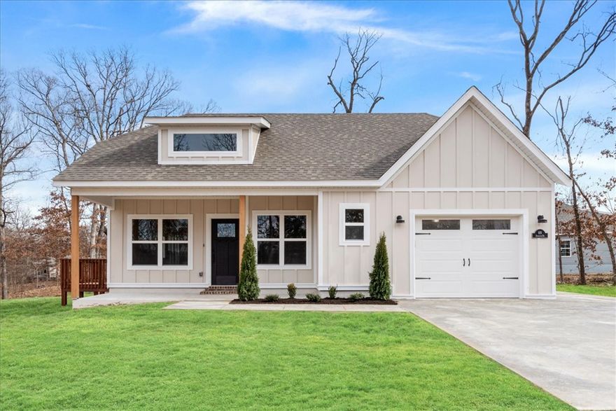 Just minutes from Lake Loch Lomond and the new Bella Vista bypass. Easy access to Bentonville. Features include NO carpet, 2'' faux blinds, cathedral ceiling with beams, custom cabinets, 3 cm countertops, gas range, black stainless appliances, double vanity, large walk-in tile shower, covered patio, additional parking pad off driveway, and high-end finishes throughout!