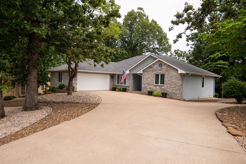 This is your ready to move-in home. Beautifully landscaped, private backyard with a deck and screened-in porch looking over the private backyard. This home has everything you could ask for ask for over sized garage, new HVAC and Water Heater, Shop in the lower level with an outside entrance. Washer, Dryer and Refrigerator all convey. You have to see this home soon it will not be on the market long. This is one of Bella Vistas best. Three minutes to the Highlands Golf Course.