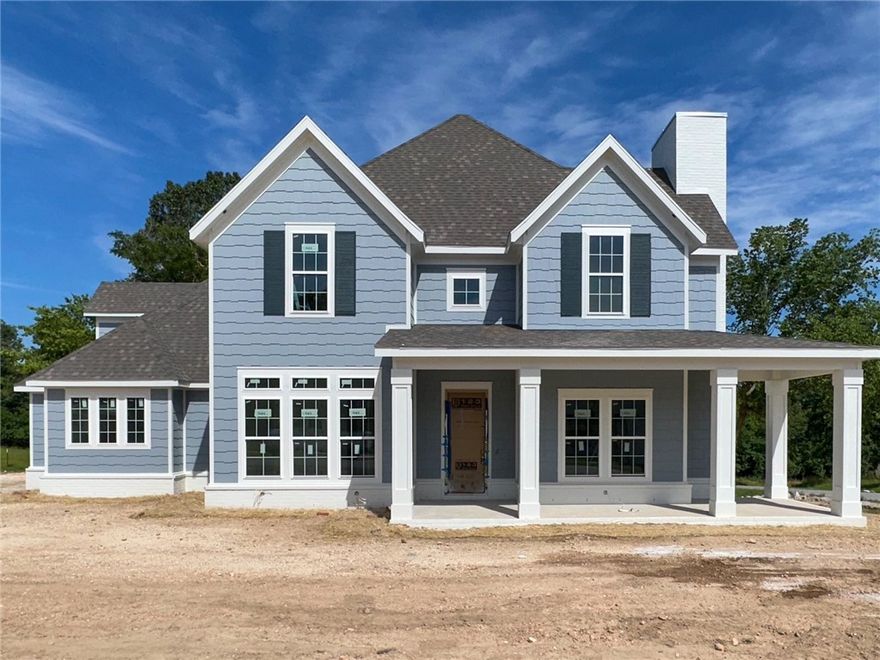 Welcome to this new single-family home in Fayetteville's tranquil, nature-inspired Blackberry Ridge, thoughtfully drafted and designed by Lane Crosno Designs. The kitchen features dual oversized islands, a convenient prep sink, 3CM quartz countertops, high-end Cafe stainless-steel appliances, and a butler's pantry. The living room has a two-story vaulted ceiling, a wood-burning fireplace, and large windows for natural light. Engineered hardwood flooring runs throughout the main areas, including downstairs bedrooms and stairs. The owner’s suite boasts a vaulted ceiling, walk-in closet, and a spa-like bathroom with dual vanities, a makeup vanity, walk-in shower with bench, freestanding tub, and private water closet. Upstairs includes a bonus room, three bedrooms, and two full bathrooms. A three-car garage offers extra storage and is prewired for an EV charger. The partially covered back porch with a ceiling fan and CAT6 cable hookup overlooks the wooded backyard, ideal for outdoor enjoyment. *AGENT OWNED*
