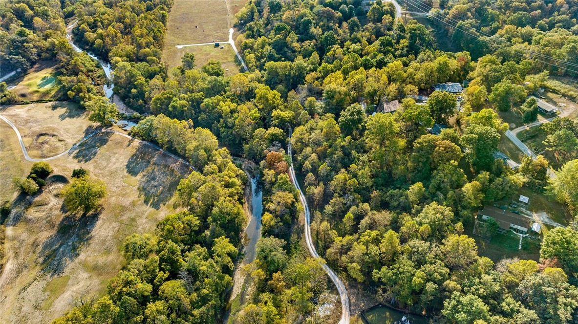 This rare 29.155-acre property offers incredible potential for a variety of uses. The 2.154-acre creekside lot features stunning views of Sugar Creek—an ideal spot for your dream home—while the adjacent land provides privacy and easy access. The remaining acreage, currently farmed as open pastures, includes multiple potential building sites. With privacy, seclusion, and versatile land, it’s perfect for anyone seeking to build, farm, or invest. Whether you envision a private estate, a family compound, or agricultural development, this property offers limitless possibilities. Enjoy peaceful living with private access, yet still close to amenities. Don't miss this unique opportunity to create the perfect space for your future. Additionally listed at 1308161