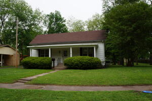 A very unique home, this home is one of the oldest homes in Dardanelle, Arkansas. The bedroom on the front of the house was originally a one room log cabin. A new heating and air unit was installed recently. It features 2 large living areas. and a formal dining area. 2 bedrooms, the second living area can very easily convert into to a 3rd bedroom. 2 baths. A beautiful sunroom is perfect for relaxing. The garage has a ramp installed for ease for a wheelchair. there is an additional bay with a door to keep lawn mower and equipment in as well as a separate shop area attached. The house was added on around 1900, The alley on the left of the house serves as the driveway. The lot is extra-large and has pecan trees. The home is being sold ''as Is'' & will require cash or conventional loa