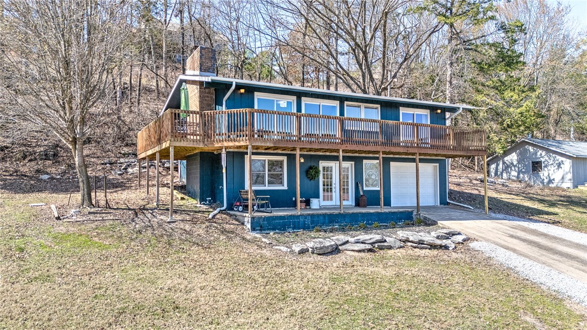 This charming, cottage-inspired home is the ultimate retreat, offering the perfect blend of rustic charm and modern comfort, just moments from the serene shores of Beaver Lake. With lake views, this property creates a tranquil sanctuary for those seeking peaceful, rural living. Located just four miles from Hobbs State Park, this enchanting residence is a nature lover’s dream, offering the ideal balance of seclusion and convenience with easy access to outdoor adventures. The home has been thoughtfully updated with a new roof, fresh flooring, sleek countertops, and new appliances, ensuring a comfortable and worry-free lifestyle. Whether you’re looking to unwind, recharge, or take in the breathtaking vistas of Beaver Lake, this home offers the perfect backdrop for relaxation and rejuvenation. Note: Subject to lot line adjustment, acreage will adjust slightly on the backside of the property. Discover your own personal haven in this one-of-a-kind property—your dream home awaits!