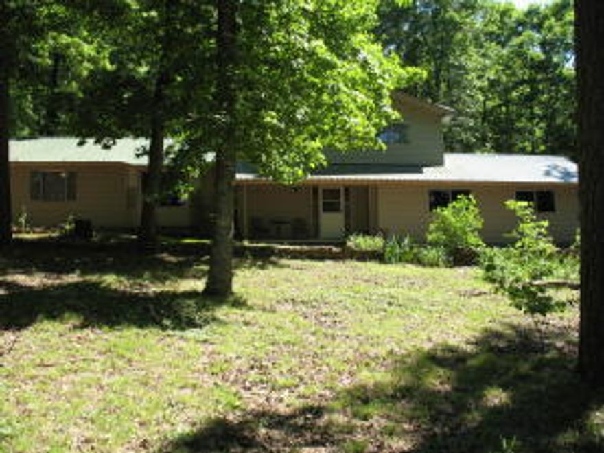 HOUSE AND 8.62 ACRES ADJOINING NATIONAL FOREST ON THE BACK OF PROPERTY WITH WILD LIFE REFUGE WITHIN WALKING DISTANCE.3 bedroom 2 full bath with beautiful bamboo and maple flooring. This Pet free ,smoke free home offers a central H&A system that is less than 2 years old and still under warranty.Metal Roof that is less than 5 years old.Kitchen Bar and double kitchen sinks.Built in book cases.Garage with a tool room work area. Don't let this one get away!!!