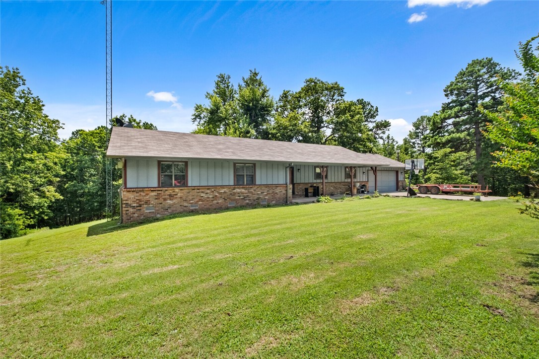 Welcome to this little slice of heaven just 2.3mi from Rocky Branch Marina! Set on an expansive 6.6-acre lot, this charming 3bed/2 bath home offers 1,668sqft of living space. Special features include a floor-to-ceiling brick wood-burning fireplace, spacious kitchen, open dining area & a covered front porch. Take in nature surrounded by your wooded view on expansive outdoor deck (New this past year). Property also has had new roof in July of 2025. Primary ensuite has a nice walk-in closet and beautiful serene view out of the bedroom windows. This gem is just a short 14-mile drive to downtown Rogers, offering the perfect balance of serene seclusion & urban convenience. Oversized 2 car garage. Don't wait on this one, it won't last long!