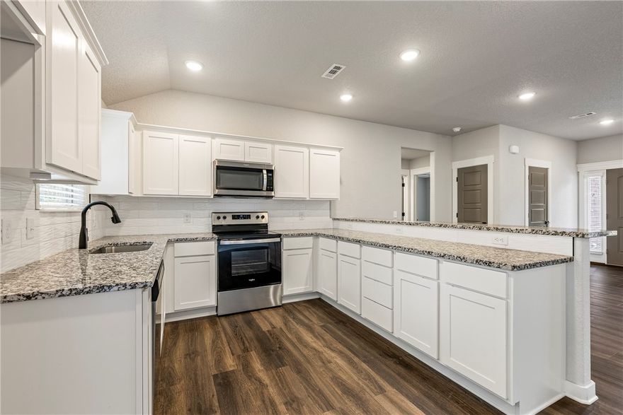 Welcome to the world’s mountain biking capital—where adventure meets comfort! This 2023 built home has barely been lived in and feels like brand new, designed with a split floor plan that makes everyday living easy. Step inside and you’ll love the open flow, high-quality finishes, and thoughtful details that make the space feel both stylish and functional. Move-in is seamless with gutters and custom blinds already in place. The kitchen is a dream with granite counters and a custom backsplash, while the primary suite offers a spa-like escape with its custom tile shower. Even better, a second parcel conveys, giving you a total of .65 acres—perfect for extra privacy, outdoor gatherings, or future plans. Location seals the deal: just minutes from the new mountain bike park, grocery store, and local restaurants in both NWA and MO. Here, you can live in style, surrounded by nature’s beauty, and enjoy a vibrant lifestyle that puts trails, dining, and community right at your doorstep.
