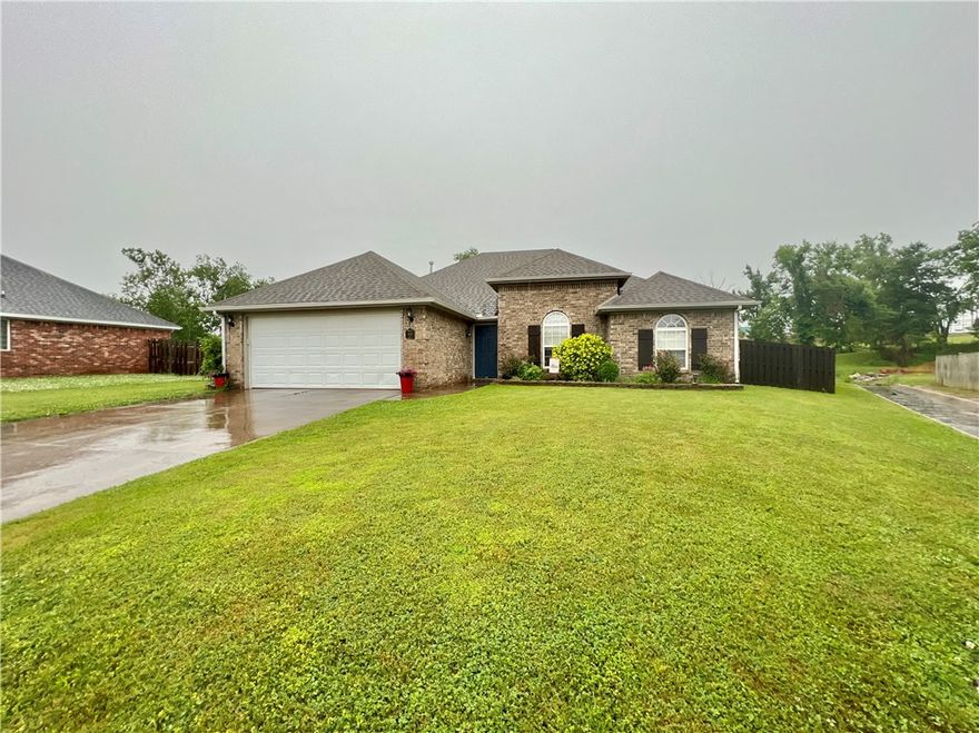 Discover this gem in the popular subdivision of Sienna Estates in Centerton! The property backs up to McKissik Park behind the home, walking distance to the splash pad, community fishing pond and trails. Subdivision also features a community pool, park, fitness room and clubhouse that homeowners can enjoy. Property sits on .30 acres and features 3 bedrooms and 2 bathrooms with a split floorplan. Kitchen includes pantry, stainless steel appliances and electric range. Kitchen opens to dining area and large living room with exposed wood beams gas fireplace and mantle that matches. Primary suite is oversized and has the same details shiplap, exposed wood beams and wood door. Primary bathroom has an ensuite that contains large whirlpool tub, stand up shower, extra storage and dual vanities. The back yard is spacious, open and has access to the back gate where you can cut thru to the new park and splash park. Raised planters have been added to grow perfect vegetables in the side yard. Perfect yard for a growing family!