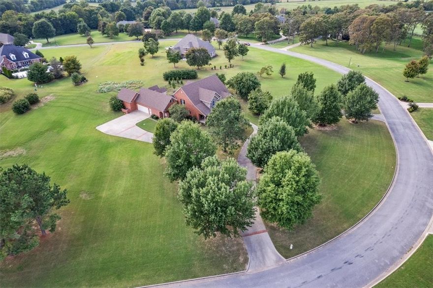 Nestled in the sought-after Vineyard subdivision, this stunning five-bedroom, four-and-a-half-bath estate offers beautifully designed living space on more than two acres of landscaped grounds. A tree-lined circle drive welcomes you to the property, where you’ll find a spacious layout with multiple bonus rooms/dedicated office, and a large primary suite complete with a private sitting area. A thoughtfully designed utility room with built-ins adds everyday convenience, while a welcoming guest room provides comfort for visitors. Outside, the covered patio overlooks the gorgeous landscaping, creating the perfect setting for entertaining or simply enjoying the serenity of the property. This exceptional estate combines elegance, function, and space in a premier location.