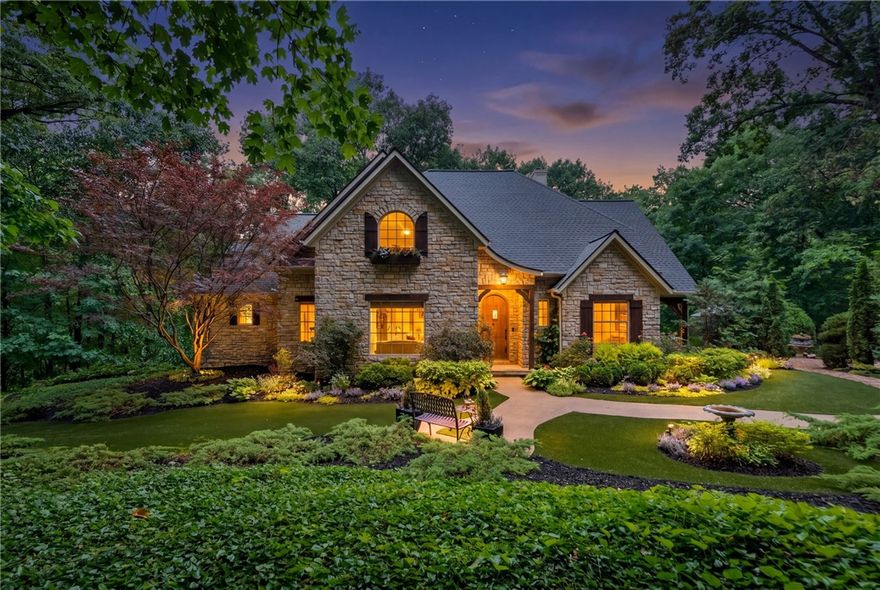 Nestled in the peaceful forest of Eureka Springs, this one-of-a-kind custom home feels like a true storybook retreat. Thoughtfully designed and lovingly built, the property blends natural beauty, privacy, and timeless charm. A picturesque wishing well welcomes you home, leading into a stunning cobblestone courtyard with outdoor fire pit and enchanting entertainment spaces made for gathering under the stars. Expansive decks and a treehouse-style screened porch immerse you in the surrounding forest canopy, creating a peaceful connection to nature from every angle. The carriage house includes an unfinished apartment above, offering endless possibilities for guest quarters, studio space, or future expansion. Rarely does a property capture this level of warmth, character, and tranquility while remaining just minutes from the charm, dining, and recreation of Eureka Springs & Holiday Island.