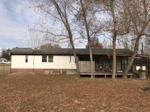 Mobile with nice carpet and laminate floors. Very clean home and very affordable housing. 12'x20' rear covered deck. 32'x18' detached shop with living quarters, 8'x16' front covered deck. .83 of an acre m/l corner lot. Just off Exit 55. 3 year old hot water heater.Sold as is at this price. Seller will not do any repairs. There is a sewer hook up for an RV on the property.