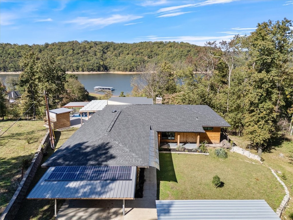 Don't miss out on this lakehome, priced below appraised value! Enjoy stunning lake views from this beautifully updated 2 BR / 2 BA home on a private 1-acre lot. Modern design meets rustic charm with pine log siding, open-concept living, and 2022 upgrades including new roof, HVAC, windows, water heaters, kitchen appliances, smart toilets, and additional storage beneath the home. Relax in the 1,500-gallon plunge pool (new pump) overlooking the lake or take advantage of six solar panels powering a backup system that runs portions of the home for 2ā3 days. Added carport space, privacy, and efficient living make this home truly special. Refrigerator, washer, and dryer convey. Listed below appraisal valueādonāt miss this unique lakeside retreat!