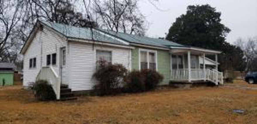 4 bedroom 1 bath home across from the Dardanelle Intermediate School. Sitting on 3 lots with a carport and a storage building. This home  has lots of potential, with original hardwood floors in the Living Room and the hall.