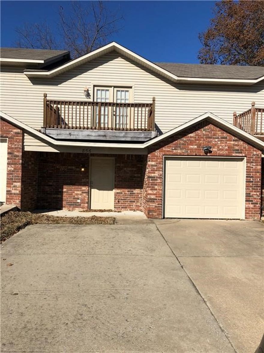 Opportunity is knocking! 3 bedroom, 2.5 bath, 1 car garage townhome located near the University of Arkansas & conveniently situated along the bus route. Covered front porch, balcony off MBR, fireplace with gas logs and a security system.