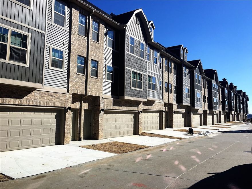 Located near the University of Arkansas, I-49, and Centennial Park! Three story townhome with 2 car garage; second floor includes, living room, dining room and kitchen with stainless appliances including refrigerator, island, pantry, and half bath. Walk out deck off kitchen. Third floor includes 2 bedrooms, 2 bathrooms, and washer/dryer. No showings until July 1. Ready for move in mid-July. Photos are of a similar unit and represent the finishes of the development.
