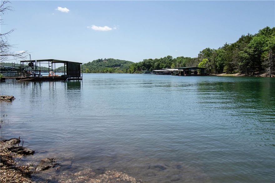 Motivated Seller, Escape to your new water front Lost Bridge Village lake home or Airbnb on Beaver Lake! Enjoy stunning views, fishing, kayaking, or simply relaxing just steps away from the lakes edge. This cozy gingerbread cabin features a spacious living area, fireplace, fully equipped kitchen, comfortable bedrooms, sauna and 6 person hot tub with an outdoor shower. This profitable Airbnb with 69k ROI in 2024, sleeps 10 and just had a kitchen remodel 3 years ago with stainless steel appliances. Not only does it have cedar throughout the home, it has skylights in the living and dining room to enhance the stone flooring and cabin features. Can you imagine your evenings on one of the two decks, or sitting by the fire pit enjoying the lake breeze and breathtaking sunsets? With a community pool, boat ramp, tennis courts and hiking trails all near the state park? This Stitt built home was designed to minimize environmental impact and promote a healthier lifestyle. It's time to make waves and host your next guest.