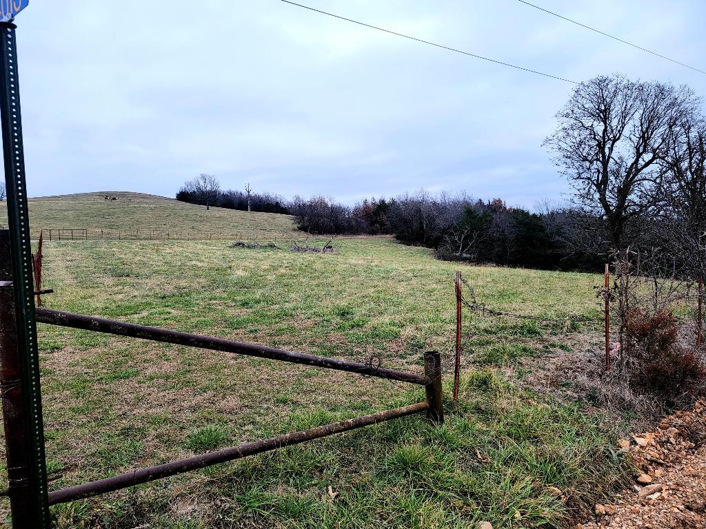 Looking for a country setting with approximately 5 acres to build your home? Check out this partly cleared land in a peaceful area with a beautiful view. It is fenced on 3 sides with water and electric at the road. Buyer to verify availability of utilities.