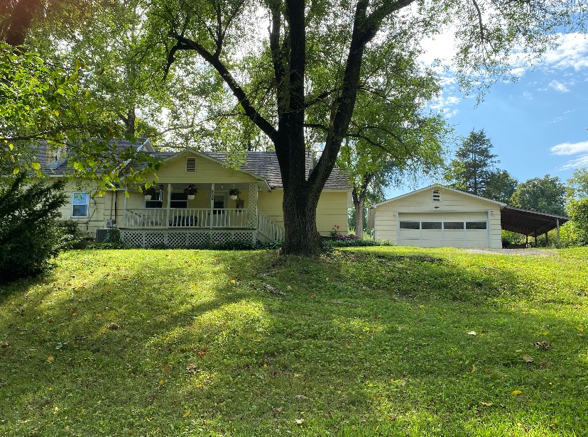 Nestled on 5 acres with a pond, this Charming 3 bed/2 bath home offers the perfect blend of Comfort & Tranquility! Relax in the Primary Bedroom with 2 closets and private ensuite bath. The Kitchen with Breakfast Bar, Dining & Living Room boasts plenty of space for your family! Bonus Loft space that can be dedicated as an office, hobby-room or bedroom. Gorgeous hard wood floors, Spacious pantry with Sink, Large Mudroom/Laundry room, Wood burning fireplace, Attic fan, Detached 2-car garage with built-in Cabinetry & Workbench. Outside enjoy a large covered front porch with wrap around covered porch. Perfect for indoor/outdoor living and entertaining. Fenced with Mature trees. Existing Concrete Pad with 8X20 ft. Greenhouse. Use it to build a workshop or barn to accommodate a few Horses. Washer/Dryer & Stainless Steel Fridge convey.
Historic Eureka Springs 12 miles, Beaver Lake 10 miles, Hobbs State Park 13 miles, Fayetteville 30 miles, Bentonville 33 miles. Come look In-Person to see the True Beauty of this property!