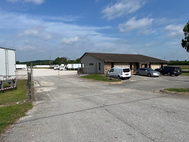 This is a land lease listing for 9.96 acres. Gravel, fenced in trucking lot that can be used for RV sales, vehicle storage, or other parking lot use. The lease is a 5 year minimum, triple NNN. This will be a prime location at the exit of the proposed Springdale bypass.