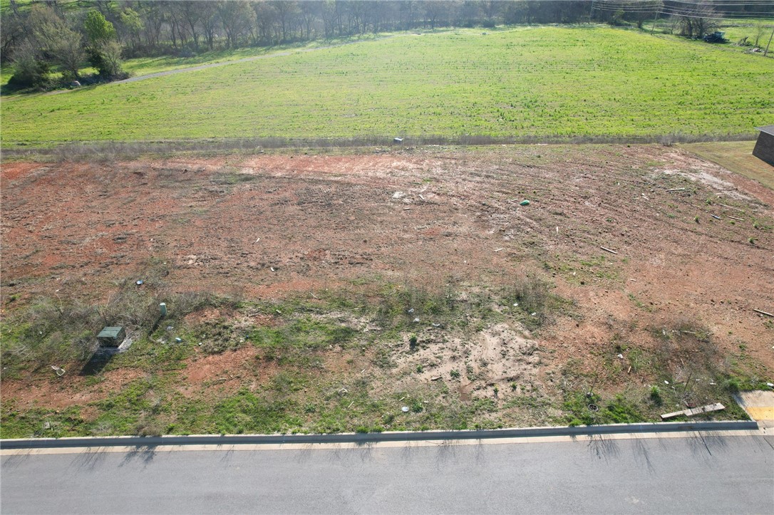 Exceptional multifamily development opportunity at the epicenter of Northwest Arkansas's explosive growth. This lot is ready to build on with roads and infrastructure complete. This strategically located property sits within one of the nation's most dynamic markets, where over 40 people move to NWA daily in 2025. As Walmart's headquarters and home to Crystal Bridges Museum, Bentonville offers world-class amenities, premier mountain biking trails, and a thriving downtown square. The multifamily market is positioned for steady growth driven by robust economic fundamentals and sustained rental demand from workforce migration. With Arkansas being the most moved-to state and Bentonville leading as the region's economic engine, this property represents a rare chance to capitalize on unprecedented regional expansion in America's fastest-growing economic hub.