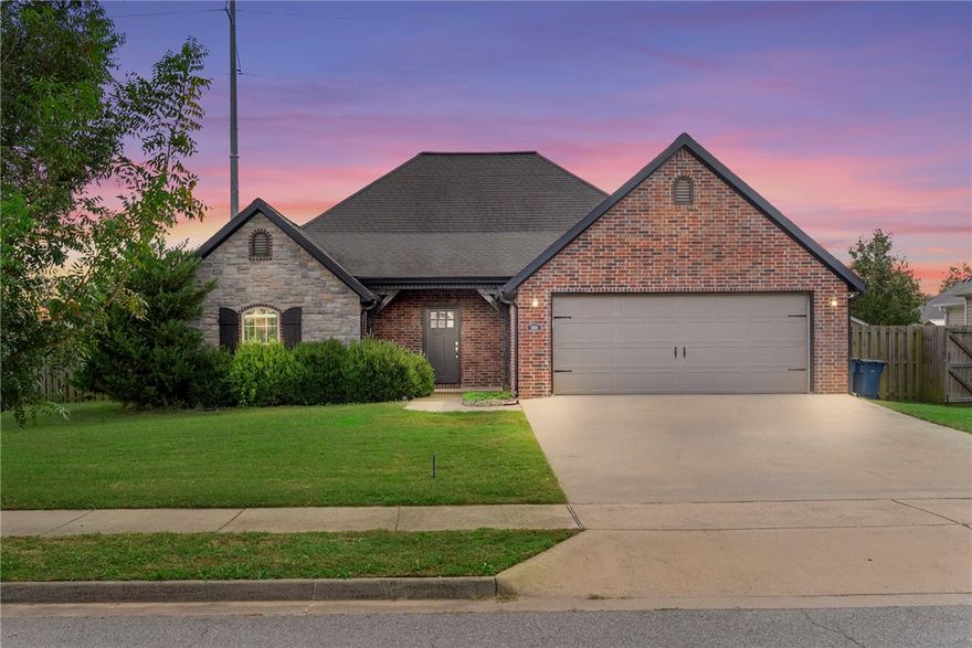 Ideally located with quick access to the 8th Street Corridor with its protected bike lane leading directly to the new Walmart Campus, this beautiful home offers timeless curb appeal with its brick-and-stone exterior and sits on a spacious .38 acre corner lot. Inside, the living room welcomes you with a soaring vaulted ceiling accented by wood beams, hardwood floors, and a cozy gas fireplace. The kitchen is designed for both style and function, featuring granite countertops, tile backsplash, bar seating, a gas range, and a walk-in pantry. The large primary suite includes a tray ceiling, while the en suite bath offers dual vanities, a soaking tub, separate shower, and his-and-hers walk-in closets. Additional highlights include a built-in mudroom bench, Nest thermostat, and thoughtful details throughout. Step outside to enjoy an oversized backyard with a firepit—perfect for entertaining! Outdoor enthusiasts will love being just minutes from Coler Mountain Bike Preserve!