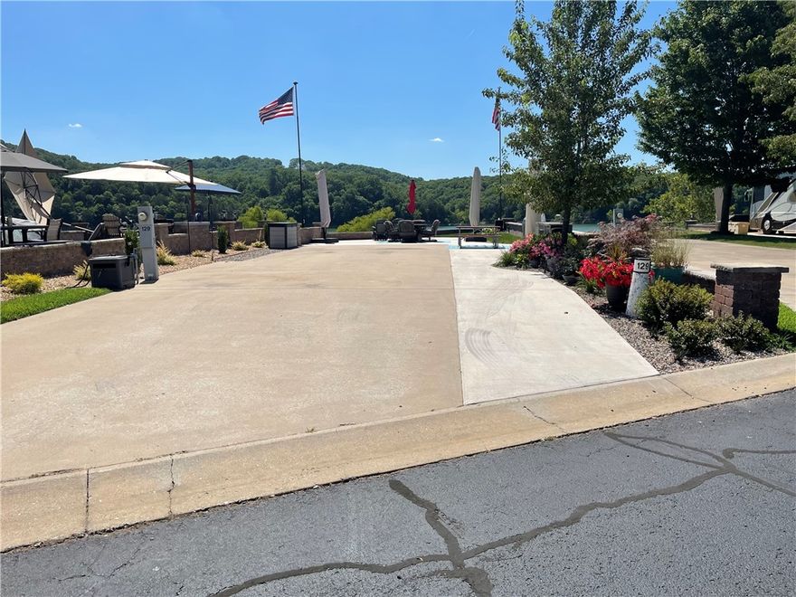 Mesmerizing Long Lake views with this gorgeous water front lot! Table Rock Lake sunsets create memories of a life time and the fishing is some of the best we have in the Ozarks. This level landscaped lot offers a wide RV space, Multitude of electrical outlets, a full outdoor kitchen complete with Large cantilever umbrella and several pieces of patio furniture for entertaining. You'll love the additional green space and the mature shade tree offered out the picture window and say hello to unobstructed views! Welcome to the Lake ** This Lot is in the rental pool. Please do not disturb the guests