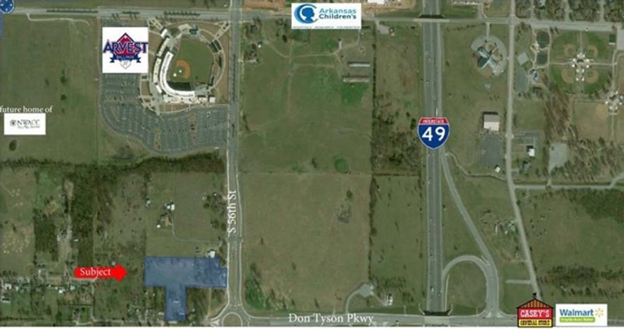 Look at the commercial/development potential on this 5+/- acres! Double entrance. Land goes around and reconnects to Don Tyson Pkwy. Great proximity to Arvest Ballpark, Children's Hospital and I-49. Commercial utilities already on property - sewer, water and electric. Level. Can be re-zoned commercial upon ownership.