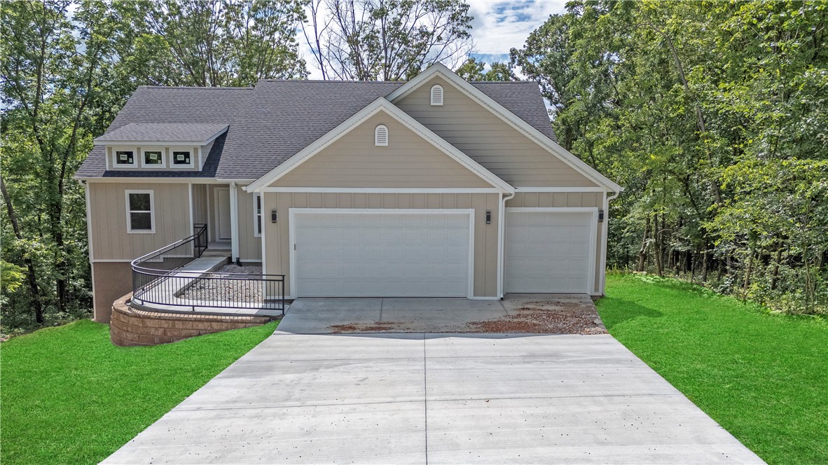 New Construction Home surrounded by trees and empty lots on each side. Landscaping is all that is left to be completed by the builder. Located at the end of a Cul-de-sac giving you privacy and the feeling of being in the country, but the convenience of easy daily commute being just minutes from I-49. The open concept with a spacious kitchen, living room and deck off the dining room makes it a perfect layout for relaxation or entertaining. The kitchen has quartz countertops, stainless steel appliances, and a spacious walk-in pantry. Additional features is the split floor plan and the office with french doors opening to the living room making it easy to work remotely. Come see this beautiful, quiet home before it's gone. Seller offering $3500 in concessions with an acceptable offer.