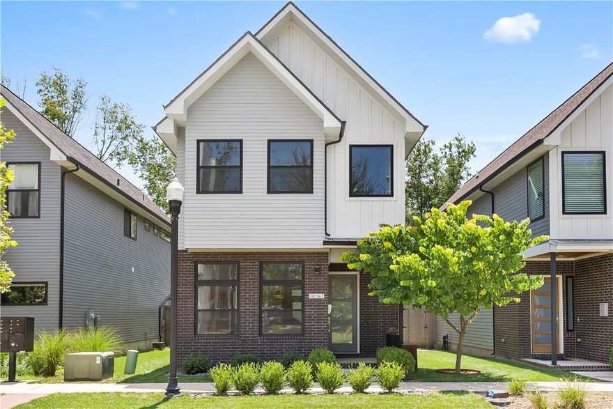 Welcome Home! The immaculate home is the perfect blend of luxury living and modern sophistication. Step into the stunning design of an open floor plan creating a seamless living space. Adorned with modern fixtures and expansive windows throughout, the home bestows beauty and an abundance of natural light. The heart of the main level is the chef's kitchen featuring quartz countertops, ample cabinet storage, and a built-in bar area with a wine fridge. Experience privacy and convenience with all bedrooms thoughtfully located on the 2nd floor along with the utility room. Enjoy the convenience of being near 8th St Market, the Square, Crystal Bridges Museum, and the Momentary. Outside you will discover a maintenance free yard complimented by a beautiful composite deck for entertainment and relaxation. Benefit from an accessible attached garage w/ an alley in the back along with the charm of a wonderful neighborhood. The exquisite ambiance of this home offers an unparalleled experience and the epitome of luxury living.