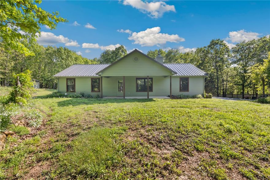 Tucked away privately off the main road, this 5-acre property offers the perfect blend of country living and modern comfort. Whether you are looking for a place to have morning coffee in the woods, room for outdoor recreation, or space to cultivate your own garden, this property has it all!  New flooring and paint throughout makes this home turn-key leaving time to fall in love with the endless outdoor potential.  Imagine sipping your morning coffee on the porch while enjoying the tranquil sounds of nature, with the convenience of a great location just a short drive from town amenities.