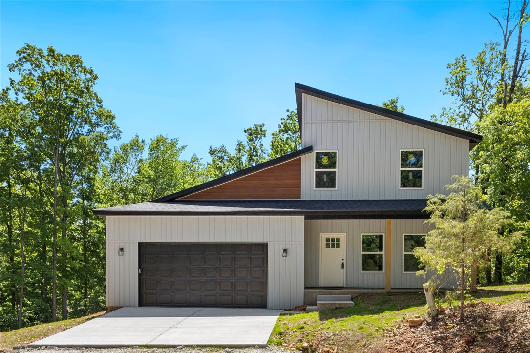 Seller is offering $5,000 to the Buyer for closing costs or buy the interest rate down. Be the first to own this beautifully designed modern home on the east side of Bella Vista. This two-story, 3-bedroom, 2.5-bath home features a spacious open floor plan, perfect for both everyday living and entertaining. The kitchen offers ample space with an island, pantry, custom cabinetry, stainless steel appliances, and granite countertops throughout the home.
The main-level primary suite includes luxury vinyl plank wood flooring, a walk-in closet, and an en-suite bath with double vanities, a soaking tub, and a separate shower. Upstairs, two generously sized bedrooms feature lush carpeting, large closets, and share a full bath with double vanity and a tub/shower combo.
Enjoy two covered porches, a two-car garage, and a large yard—ideal for outdoor living. Located just minutes from bike trails, lakes, golf courses, and more, this home blends modern comfort with the natural beauty of Bella Vista.