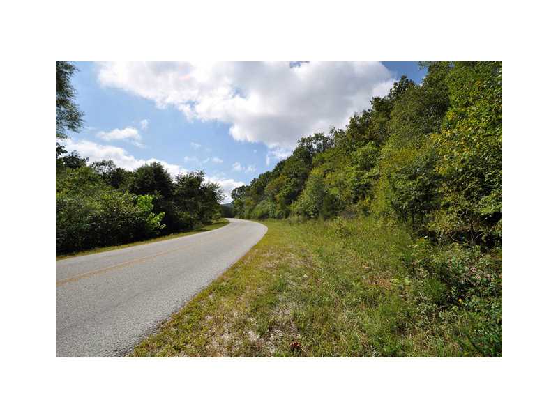Open land with beautiful creek and blacktop frontage, surrounded by plentiful woods. Additional 64 acres available(MLS#667782). Rural water available.