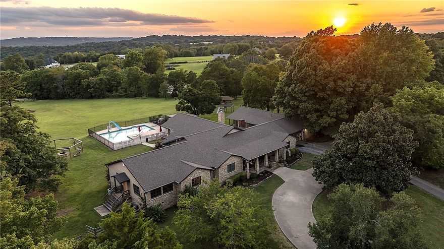 Estate property featuring custom-built, 5558 square foot, one-level Craftsman home, on 5.6 gently rolling acres. 6 bed, 4.5 bath, 2 bonus rooms, open floor plan family room with floor to ceiling windows with scenic views across river valley and mountains. New multi-use 4340 sq ft Barn/ADU built in 2022 for recreation, fitness, workshop, garage, and 840 sq ft of dedicated storage; with 1.5 baths and granite topped full kitchenette. In-ground pool, private drive, 2 laundry rooms, new roof 2022.