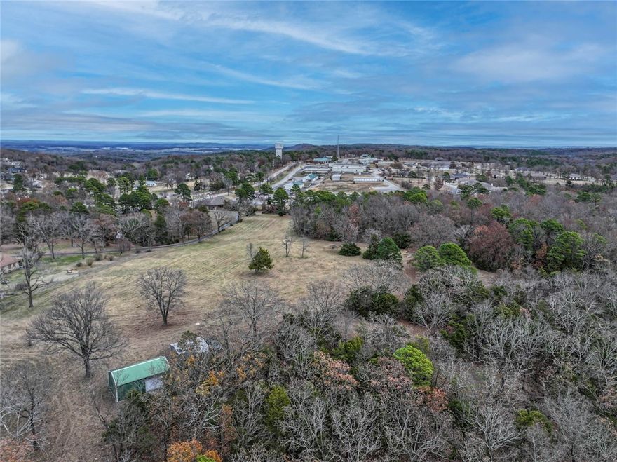 Location, Location, Location! Rare opportunity to own 55.75 acres of quality developable property with 1/3 mile frontage on Hwy 23. Amenities include grocery shopping, restaurants, banking, hardware, fire and police protection, gas, a convenience store and more are located next door. Only 5 miles to Eureka Springs and 4.5 miles to the Holiday Island Marina. Mixed topography with flat pasture, flat wooded areas and many outstanding rock outcroppings. Incredibly south-facing views including Lake Leatherwood. The perimeter is mostly fenced with roads throughout the property (some require 4WD) There is a 32 x 20 metal building and carport and electric is available on property. This is an awesome opportunity for development or to build your own country estate "in town."