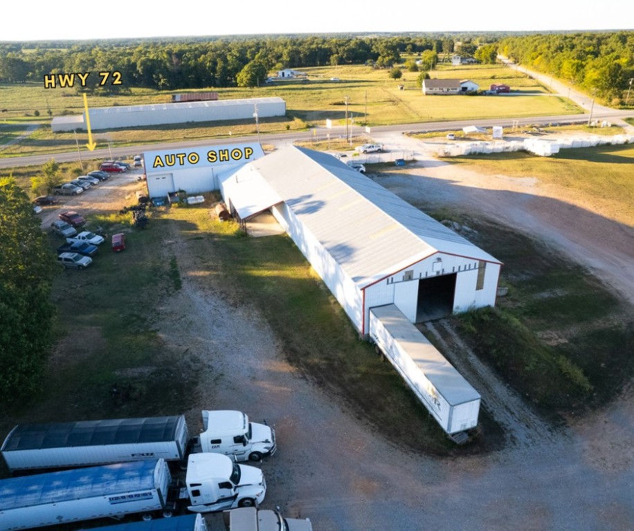 Significant development opportunity leveraging Interstate 49 and AR HWY 72 traffic. Property is appx. 800' from Exit 100 and across from the future Arkansas Welcome Center.
Easily accessible/ visible gas stations are 28 miles & 9 exits apart on this stretch of Interstate. Fast food is 30 miles apart. This property is in the middle of that stretch. Closest truck stops are 38 miles north and 17 miles south from this exit. Closest HWY 72 chain gas & food bldgs. are 8 minutes away.
The site has 476' of HWY 72 frontage. 9,400 vehicles daily at this spot, 11% trucks. This level property currently has an auto repair shop, U Haul rental, and additional shop space and trailer parking in back.