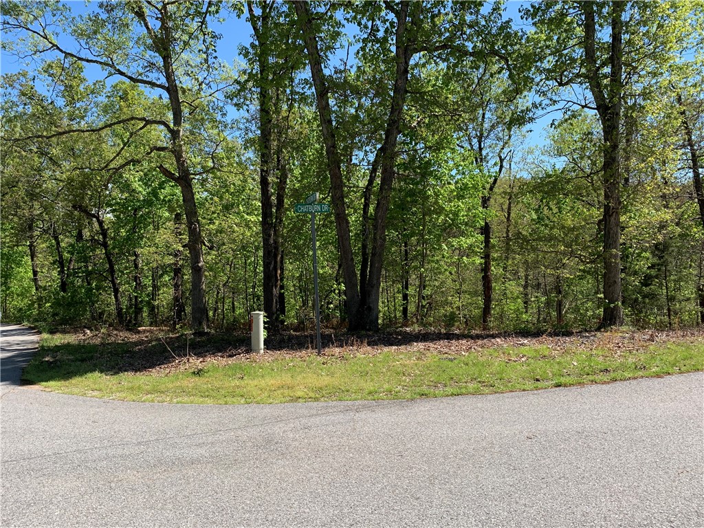 Corner lot in peaceful subdivision. Close to I49. Quick & easy access to dining, shopping. Actually have access to biking trail at end of Chatburn Dr. Lot has gentle slope for the walkout basement set up. Nice setting with mature trees and nice valley view in the back. Come build your dream home!