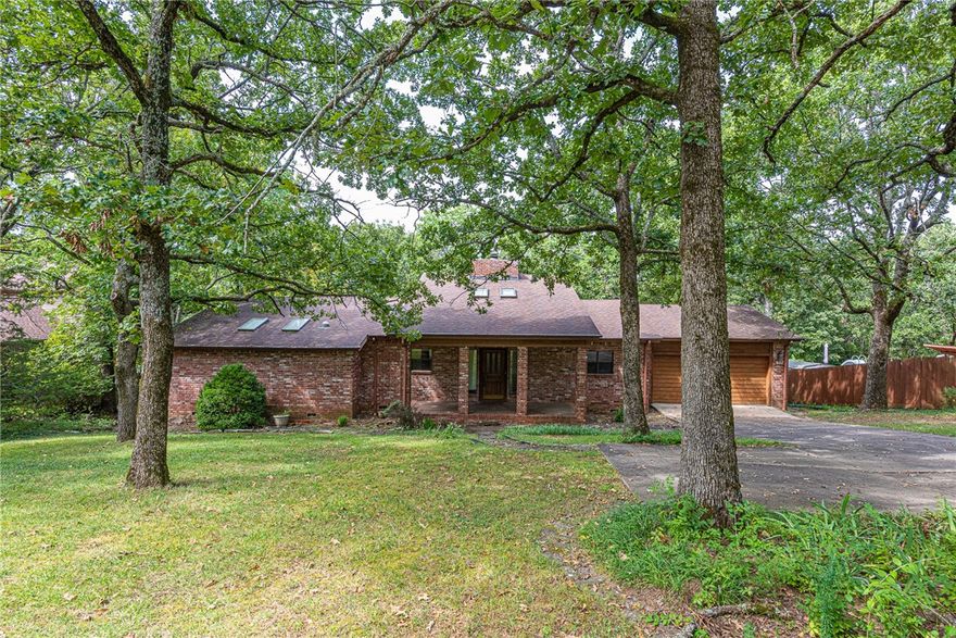 PREMIER LOCATION! This 3 bed 2 bath home is the home that you’ve been looking for!Located in the Highland park Subdivision minutes away from Parks, Schools ,shopping ,and eateries in East Fayetteville! From the covered front porch head inside to a large foyer with skylight and  split level living room with vaulted ceiling with beam,  wood burning fireplace, and wood flooring! Formal Dining room off the living room with large window and moulding details! Enjoy a U-shaped kitchen with stainless steel appliances and built-in desk! Relax in the primary bedroom with private ensuite featuring walk in closets, oversized dual sink vanity, skylight, and jacuzzi tub combo! Enjoy an additional two bedrooms and one bathroom! Head out back to the wooden deck overlooking the wooded back lawn! Don’t Miss Out! Act Now!