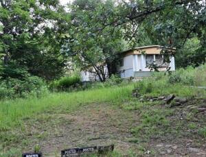 10.86 wooded acres m/l. Property is in good area for wildlife and hunting opportunities. Mobile Home is 3BR/2BA that needs extensive work or completely removed. Property is being sold AS-IS with no repairs.