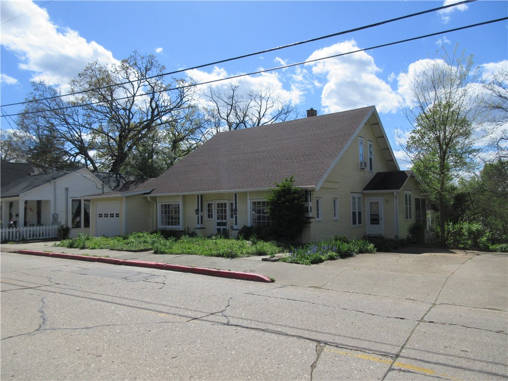 If you want a large, roomy, and well-loved home in a fantastic location, then you have found what you have been wanting. The downtown shopping district is a short walk away, and you are close to the artistic White Street area. The home features a large kitchen, a spacious formal dining room, and an additional casual dining area. It also has four large-sized bedrooms. Parking is a big plus with this propertyātwo enclosed attached garage spaces and two ample parking areas outside with access from Dickey Alley. The wooded view to the rear of this home is serene. This home also features lots of interior storage. Some recent improvements include indoor/outdoor carpeting on the expansive enclosed front porch, a new garage door, gutters, and a new washer/dryer and range hood. This rare find and location is ready for you to enjoy Eureka Springs.