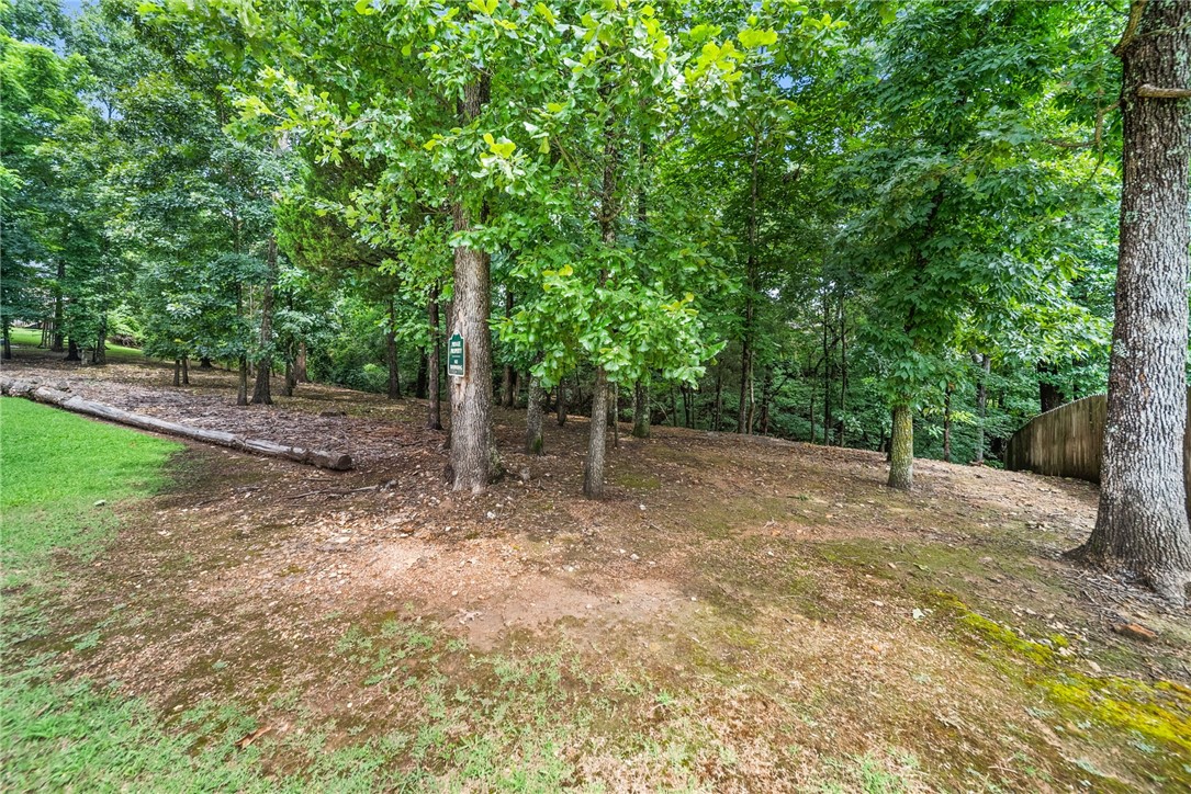 Invest in this fabulous buildable lot with ALL UTILITIES at the road and large beautiful trees to shade your new house on this quiet cut-de-sac street in the prestigious Reighton subdivision. Back 40 bike trails crosses Cresswell Dr. just up the road, Metfield Rec. Center and Dogwood Golf course are minutes away! Lot is very level near the road, and falls off the back near the holler. Owner mows the grass near the road; and picks up the woods; lot is well kept and easily walkable!