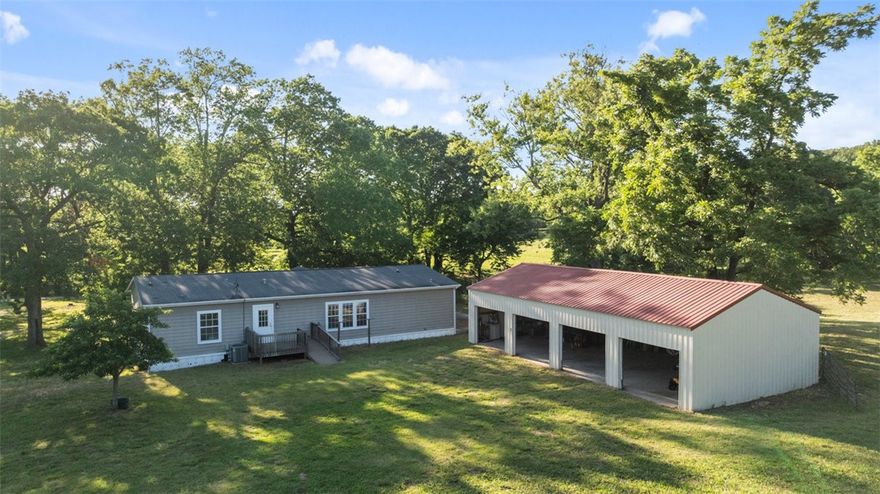 Discover 39.1 peaceful acres near Beaver Lake! This property offers endless possibilities!  Whether you're dreaming of a peaceful homestead, hobby farm, or hunting retreat, this versatile land delivers. Property features an 1,800 sq ft manufactured home. The true highlight is the land itself: a mix of open pasture and mature woods, featuring enormous dogwood trees, rich wildlife presence, and endless room to roam. Property includes a large 4 bay workshop/garage provides plenty of space for equipment, storage, or hobby use and an old barn that adds rustic character.