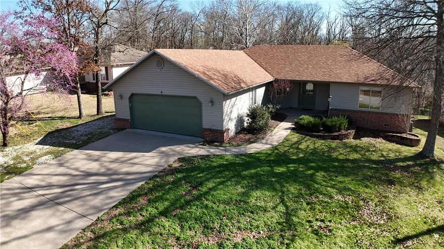 100% loan available—this home qualifies for USDA-RD financing! Located in beautiful Bella Vista, known for its miles of scenic trails, lakes, and outdoor recreation. Great location near Blowing Springs Park, and quick access to the Back 40 Trail System, including the Mighty Pine and S Upper bike trails—perfect for mountain biking and hiking enthusiasts. Enjoy the natural surroundings while still being a short drive to dining, shopping, Mercy Medical, & Cooper Elementary. Well-maintained brick & vinyl exterior home offering 3 bedrooms and 2 baths with an open floor plan & split bedroom layout. Living room features a cozy fireplace. All wood areas on the exterior, garage door, and all interior walls have been professionally painted. Heated/cooled storage room in the crawlspace—perfect for a storm shelter or additional storage. Roof approx. 2.5 yrs old and heat pump approx. 3.5 yrs old with new Wi-Fi thermostat. Video surveillance equipment conveys. 1,000-gallon concrete 3-bedroom septic tank; pump replaced 11/2023.