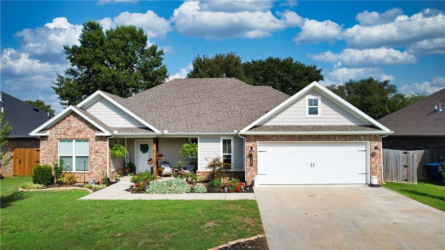 Welcome to Woodbridge Subdivision in Pea Ridge. This Craftsman-style home features 3 bedrooms & 2 bathrooms and has lots of cabinetry and storage. The open floor plan has a large kitchen island and a spacious dining area, providing an ideal setting for gatherings and entertaining guests. The primary bathroom is equipped with a large walk-in shower, a soaking tub, and a roomy walk-in closet, while the guest bathroom offers a double vanity for added convenience. Durable wood-look vinyl flooring extends throughout the home, except in wet areas which are finished with tile. Additional amenities include a privacy fence, blinds, and gutters. The covered patio is perfect for outdoor enjoyment. The exterior is brick combined with maintenance-free hardy board siding to ensure lasting appeal and minimal upkeep.