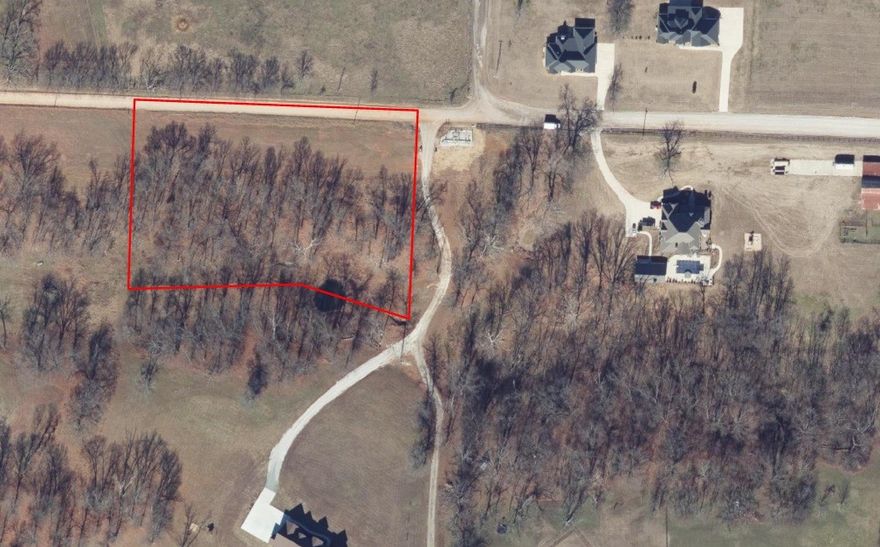 Build the lifestyle you want on this beautiful 3-acre homesite in Bentonville’s quiet countryside—partially wooded with a gentle roll and a serene shared pond. Set among large estate homes, it offers privacy without sacrificing convenience to everything Bentonville is known for: trails, parks, dining, arts, and the Walmart Home Office. The land has been surveyed; electric and gas are at the street; well and septic will be needed. Tall trees frame multiple potential build sites, with room to plan gardens, a shop, or outdoor living (subject to approvals). Deer and native wildlife roam the area, adding to the peaceful, natural setting. Perfect spot to design your custom residence and enjoy space, beauty, and proximity in one. Buyer to verify utilities, septic permitting, access, and any restrictions; confirm details of shared-pond use/maintenance.