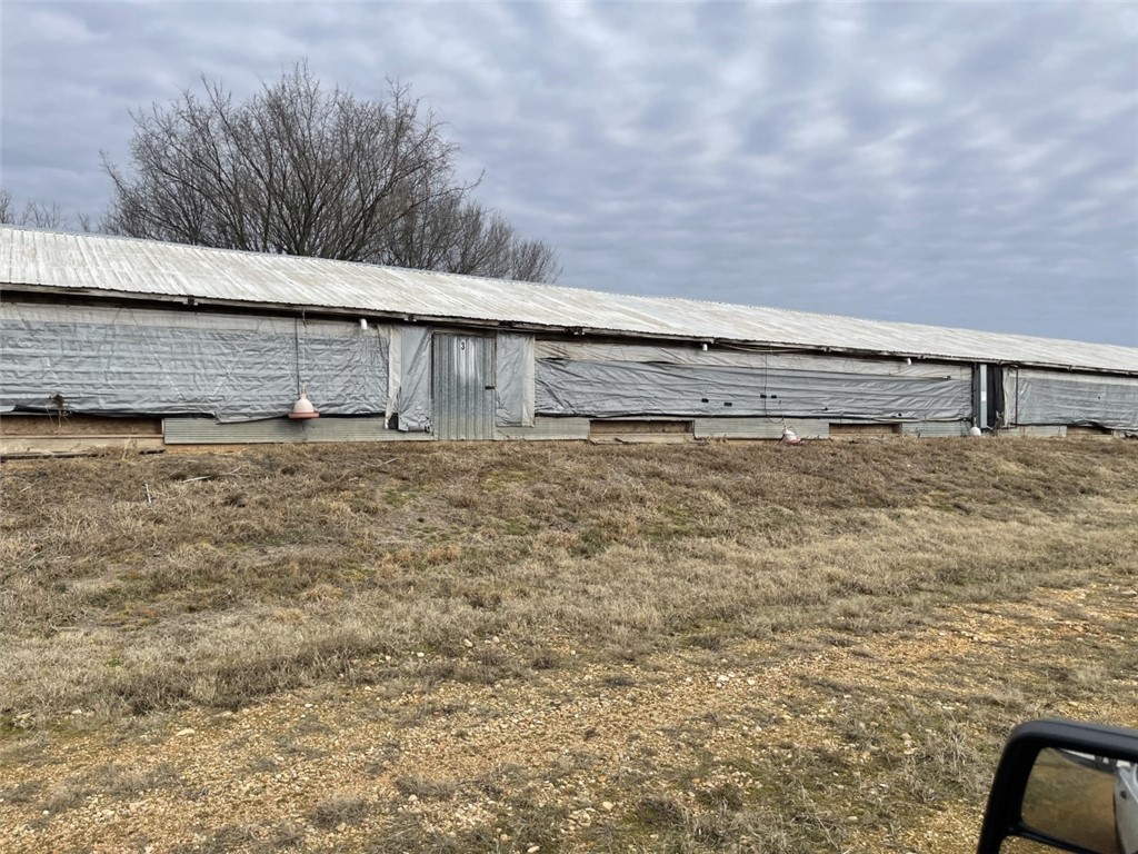 Previously a free range chicken farm, no current contract. On this farm the houses are older, smaller and no equipment is in the chicken houses. But, would make a nice farm on the edge of Gentry, and possibly a development opportunity. Sold "AS IS"