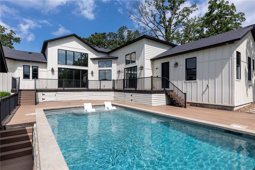 Impressive creek front estate blends elegance and functionality on 2.38 acres. With soaring 17’ ceilings and floor-to-ceiling windows, natural light and views surround you! Designed for both everyday living and unforgettable entertaining, the open-concept layout features custom finishes throughout, including a spacious chef’s kitchen, butler’s pantry,  and a fun loft space. The main residence offers 5 generous bedrooms, each with private bath access. The primary suite is a gem, and even has a hidden room! A separate wing houses secondary bedrooms and a central game room.  Above the 3-car garage, private guest quarters include a full suite with it's own entrance. Outdoor features: an inground saltwater pool, hot tub, and deck that overlooks your private acreage. A cabana w/fireplace, sport court, and firepit complete the outdoor experience. Listen to the creek ripple by and enjoy nature all around.  Live a life of comfort, style, & abundance in this truly one-of-a-kind property. Located in BHS West Zone.