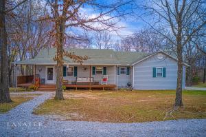 Country living close to town begins to describe this updated 3 BR 2 1/2 BA home that sits on 5.25 park like acres. This property has a lot to offer, such as a wrap around porch, updated kitchen with granite countertops, finished basement with kitchen, a 30 x 30 shop with electric and concrete floors, and an oversized garage. As an added bonus, there is a finished out tiny house with its own septic, great for long term visitors/family. Don't let this one get away!