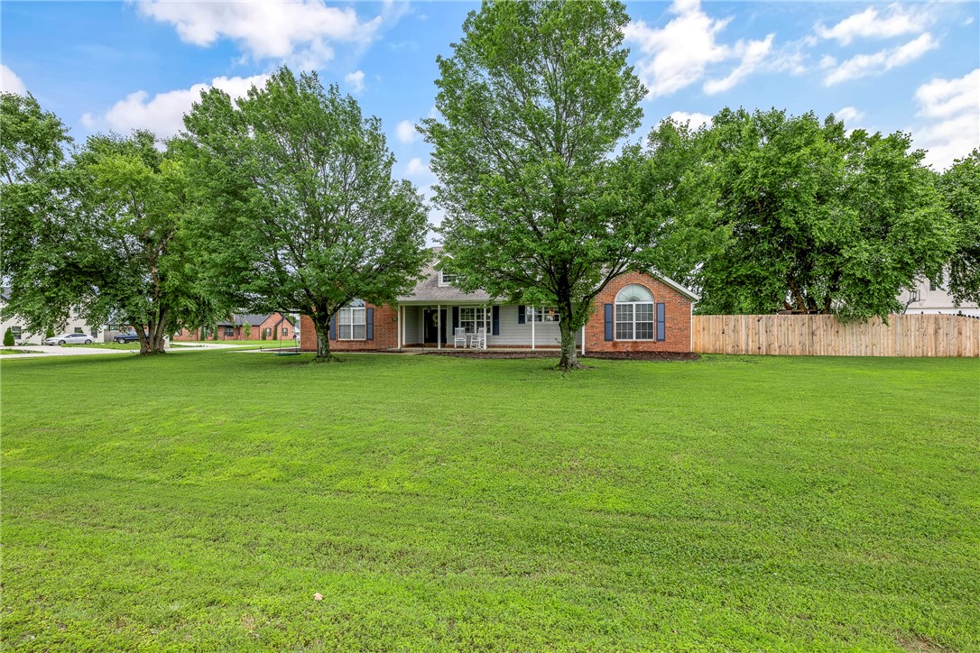 Enjoy country charm with city convenience at 372 Niagara St in Elm Springs! This fully renovated 4-bed + office, 2.5-bath, 3-car garage home sits on a flat, fully fenced 0.87-acre corner lot with mature trees and newly planted fruit trees (apple, pear, peach & cherry). Inside, you’ll find all-new paint (interior & exterior), new flooring throughout, and a spacious open-concept kitchen with beautiful quartz countertops. Large bedrooms, ample natural light, and thoughtful updates make this home move-in ready. Step out back to a huge covered patio perfect for relaxing or entertaining. Located just minutes from Elm Springs Walmart, Mercy Hospital, and Shaw Family Park with its trails and dog park. Zoned for top-rated Springdale schools: Young Elementary, Hellstern Middle, Central Jr High, and Har-Ber High. Seller offering $3,000 credit for new appliances or buyer's choice. This rare, spacious lot with modern upgrades and prime location won’t last long!