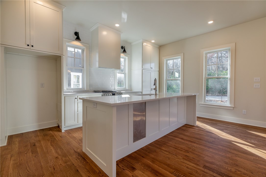 Are you ready to be stunned Northwest Arkansas? Markham Hill Phase I is underway and located in the heart and soul of Fayetteville. This one of a kind 4 bedroom, 3.5 bath home features premium finishes. The kitchen features 3cm marble, a 5 burner Kitchen aid gas range, Bosch Dishwasher, large island with counter seating, upgraded light fixtures, and views into the Living and Office Nook. Home features white oak hardwood flooring, carpet in upstairs bedrooms, tile in wet spaces, stunning light fixtures throughout, and custom details you cant put into words. Primary suite large enough for bedroom furniture plus a nice seating area, large walk-in closet with built-ins, dual vanities, all tile shower, and convenient access to the laundry room. Additional features include a 2 car garage, large wrap around front porch, James Hardie SMOOTH lap siding and rock exterior, AND walking distance to Markham Hill trails AND Donald W. Reynolds Razorback Stadium. Go Hogs!